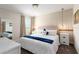 Bedroom featuring a large bed, modern decor, and a window with natural light, creating a comfortable retreat at 901 Ocean Course Ave, Davenport, FL 33896