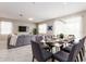 Open-concept dining area features a glass-top table and comfortable seating for a modern living experience at 901 Ocean Course Ave, Davenport, FL 33896
