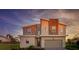Beautiful two-story home featuring stone accents, gray exterior paint, and a well-manicured lawn at 901 Ocean Course Ave, Davenport, FL 33896