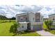 Stylish two-story home featuring modern design, stone accents, and beautiful green lawn at 901 Ocean Course Ave, Davenport, FL 33896