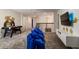 Upstairs game room with a Minion theme, air hockey table, TV, and cozy beanbag seating area at 901 Ocean Course Ave, Davenport, FL 33896