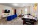 Cheerful game room with air hockey table, television, beanbag chairs, and playful Minion decor at 901 Ocean Course Ave, Davenport, FL 33896