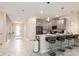 Stylish kitchen with modern grey cabinetry, stainless steel appliances, and a breakfast bar with seating at 901 Ocean Course Ave, Davenport, FL 33896