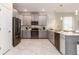 Contemporary kitchen featuring stainless steel appliances, sleek grey cabinets, and a breakfast bar island at 901 Ocean Course Ave, Davenport, FL 33896