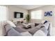 Cozy living room with a gray sectional sofa, modern coffee table, and wall-mounted television at 901 Ocean Course Ave, Davenport, FL 33896