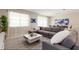 Bright living room featuring a comfortable gray sofa and a center coffee table on a stylish rug at 901 Ocean Course Ave, Davenport, FL 33896