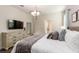 Bright main bedroom featuring a stylish chandelier and neutral decor at 901 Ocean Course Ave, Davenport, FL 33896