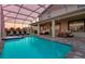 A refreshing swimming pool with an attached spa, comfortable patio seating and outdoor dining at 901 Ocean Course Ave, Davenport, FL 33896