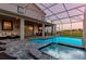 Screened-in pool with integrated spa, plus outdoor seating area perfect for relaxation and entertaining at 901 Ocean Course Ave, Davenport, FL 33896