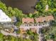 Aerial view of a condo complex with a lake, lush landscaping, and red tiled roofs at 960 Mooring Ave # 202, Altamonte Springs, FL 32714