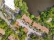 Aerial view of a condo complex with a lake, parking, lush landscaping, and red tiled roofs at 960 Mooring Ave # 202, Altamonte Springs, FL 32714