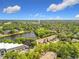 Expansive aerial view with a lake, trees, and condo community in the distance at 960 Mooring Ave # 202, Altamonte Springs, FL 32714