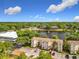 Overhead shot highlighting the condos, parking, and a nearby lake with fountains at 960 Mooring Ave # 202, Altamonte Springs, FL 32714