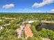 Community aerial view featuring parking and a peaceful lake, all set against a backdrop of abundant trees at 960 Mooring Ave # 202, Altamonte Springs, FL 32714
