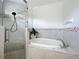 Bathroom showcasing a glass-enclosed shower and a separate soaking tub with updated fixtures at 960 Mooring Ave # 202, Altamonte Springs, FL 32714