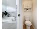 Bathroom featuring soaking tub, toilet and storage with mosaic tile accents at 960 Mooring Ave # 202, Altamonte Springs, FL 32714