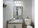 Bathroom with a granite countertop, framed mirror, and modern lighting at 960 Mooring Ave # 202, Altamonte Springs, FL 32714