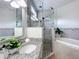Renovated bathroom featuring granite countertops, glass shower, soaking tub, and stylish mosaic tile at 960 Mooring Ave # 202, Altamonte Springs, FL 32714