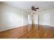 Hardwood floors enhance this expansive bedroom with multiple doorways and a ceiling fan at 960 Mooring Ave # 202, Altamonte Springs, FL 32714