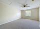 This bedroom features a ceiling fan, neutral carpet and paint, and a window at 960 Mooring Ave # 202, Altamonte Springs, FL 32714
