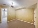Spacious carpeted bedroom with a decorative chandelier and neutral paint at 960 Mooring Ave # 202, Altamonte Springs, FL 32714