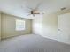 Bedroom featuring a ceiling fan, neutral carpet and paint, and window at 960 Mooring Ave # 202, Altamonte Springs, FL 32714