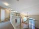Open foyer with a white railing overlooking the downstairs living spaces at 960 Mooring Ave # 202, Altamonte Springs, FL 32714