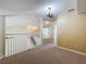 Upstairs hallway with neutral carpeting and view into other rooms at 960 Mooring Ave # 202, Altamonte Springs, FL 32714
