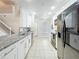 Stylish kitchen with granite countertops, white cabinets, stainless sink, and modern black appliances at 960 Mooring Ave # 202, Altamonte Springs, FL 32714