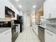 Modern kitchen features white cabinets, granite countertops, stainless steel appliances, and stylish backsplash at 960 Mooring Ave # 202, Altamonte Springs, FL 32714
