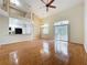 Open-concept living area with hardwood floors, leading into a kitchen and featuring a staircase to a loft at 960 Mooring Ave # 202, Altamonte Springs, FL 32714