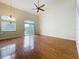 Spacious living room features hardwood floors, high ceilings, fan, and balcony access with great natural light at 960 Mooring Ave # 202, Altamonte Springs, FL 32714