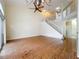 Bright living room features hardwood floors, fan, staircase to loft, and sliding glass doors to balcony at 960 Mooring Ave # 202, Altamonte Springs, FL 32714