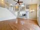 Expansive living area showcasing hardwood floors, staircase, a fan, and a kitchen with modern appliances at 960 Mooring Ave # 202, Altamonte Springs, FL 32714