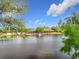 A scenic water view featuring a peaceful lake and a building in the background, framed by lush green trees at 960 Mooring Ave # 202, Altamonte Springs, FL 32714