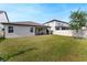 Spacious backyard featuring a lush green lawn, and a covered patio at 10072 Hampshire Oaks Dr, Orlando, FL 32825