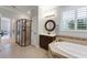 Bathroom featuring a large shower and a soaking tub with neutral tile at 10072 Hampshire Oaks Dr, Orlando, FL 32825