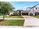 Beautiful one-story home with brick-paved driveway, complemented by mature trees and lush lawn at 10072 Hampshire Oaks Dr, Orlando, FL 32825