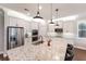 Modern kitchen featuring stainless steel appliances, granite countertops, and pendant lighting at 10072 Hampshire Oaks Dr, Orlando, FL 32825