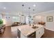 Open-concept kitchen featuring granite countertops and views of the living and dining areas at 10072 Hampshire Oaks Dr, Orlando, FL 32825