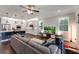 Cozy living room with hardwood floors, ceiling fan, and large windows offering natural light at 10072 Hampshire Oaks Dr, Orlando, FL 32825