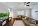 Spacious living room with hardwood floors, sectional sofa, and a modern entertainment center at 10072 Hampshire Oaks Dr, Orlando, FL 32825