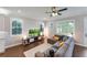 Open living area with hardwood floors and comfortable seating, offering plenty of natural light at 10072 Hampshire Oaks Dr, Orlando, FL 32825