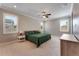 Bedroom featuring large windows, neutral walls, and a ceiling fan with a light fixture at 10072 Hampshire Oaks Dr, Orlando, FL 32825