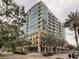 Contemporary condo building featuring balconies, ground-floor restaurant, and well-maintained landscaping, creating an inviting urban ambiance at 101 S Eola Dr # 720, Orlando, FL 32801