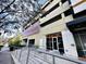 Street-level entrance featuring accessibility ramp, glass doors, and nearby landscaping for a welcoming experience at 101 S Eola Dr # 720, Orlando, FL 32801