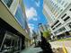 Eye-level exterior view of the building showcasing its modern architecture and beautiful blue sky at 101 S Eola Dr # 720, Orlando, FL 32801