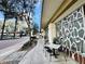 Relaxing outdoor seating area on a sidewalk near a modern condo building, surrounded by trees and greenery at 101 S Eola Dr # 720, Orlando, FL 32801
