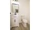 Modern half bathroom with a white vanity, black fixtures and framed mirror at 1016 E Fillmore Ave, Orlando, FL 32809