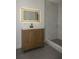 Modern bathroom featuring a wood vanity, LED mirror, and tiled walk-in shower at 1016 E Fillmore Ave, Orlando, FL 32809